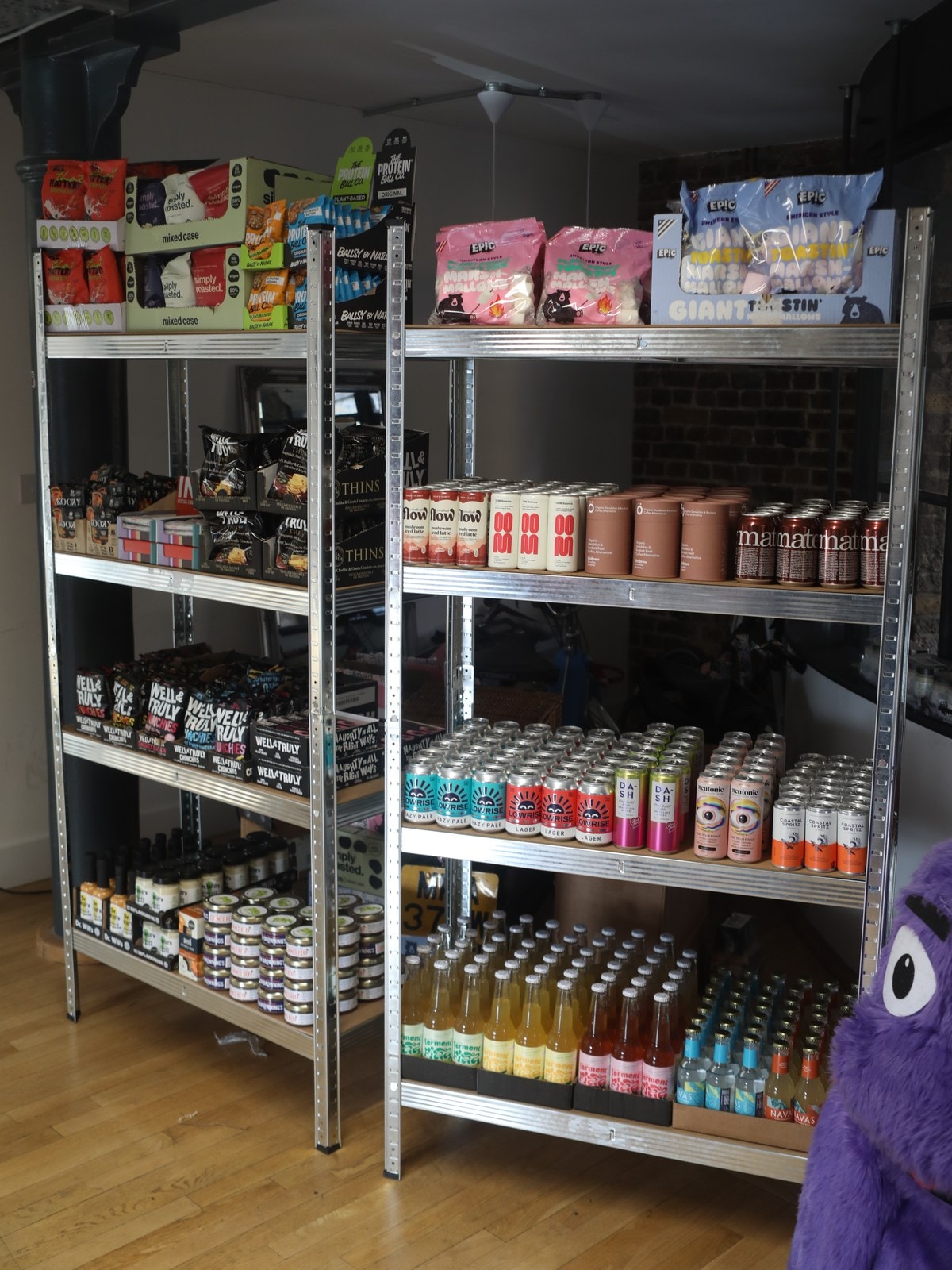 The Shelf: two shelving units stacked with snacks and drinks from the partner brands