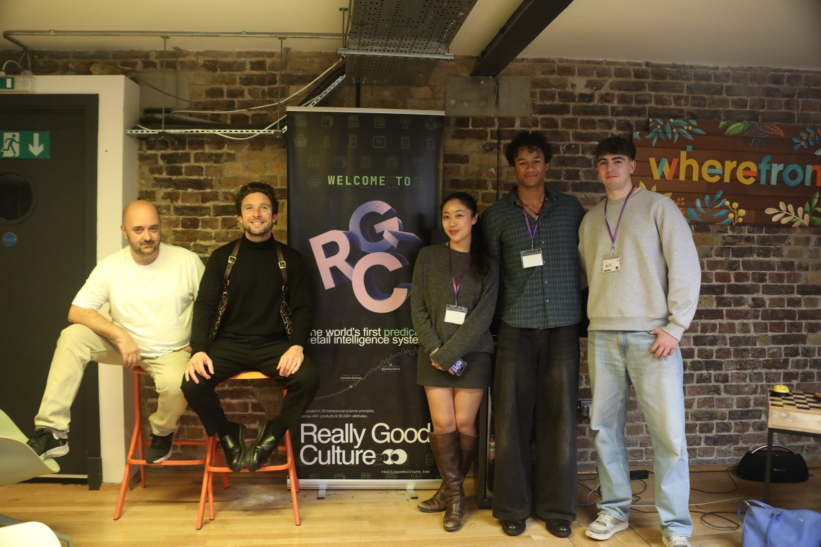 Oriol and Gianni with the Really Good Culture team in front of the welcome banner